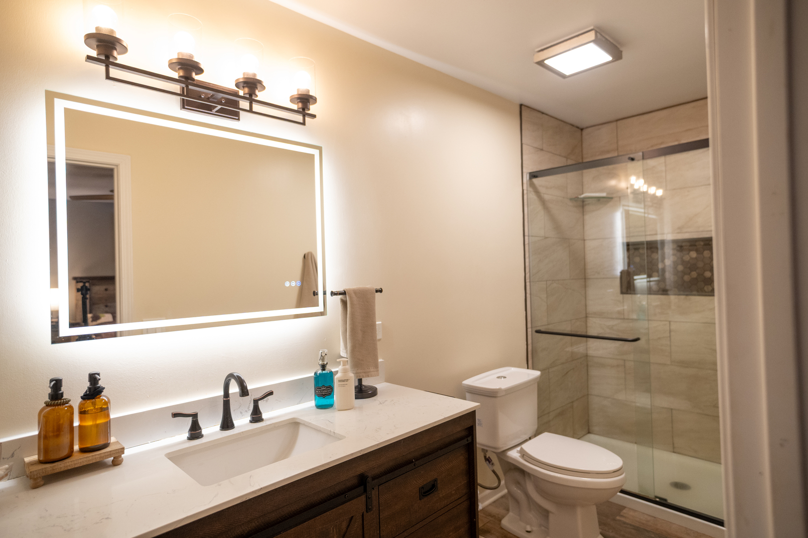 1403 West Beach Road Waukegan, IL 60087 - Photo 30 of 59 a bathroom with a sink a toilet a mirror and shower