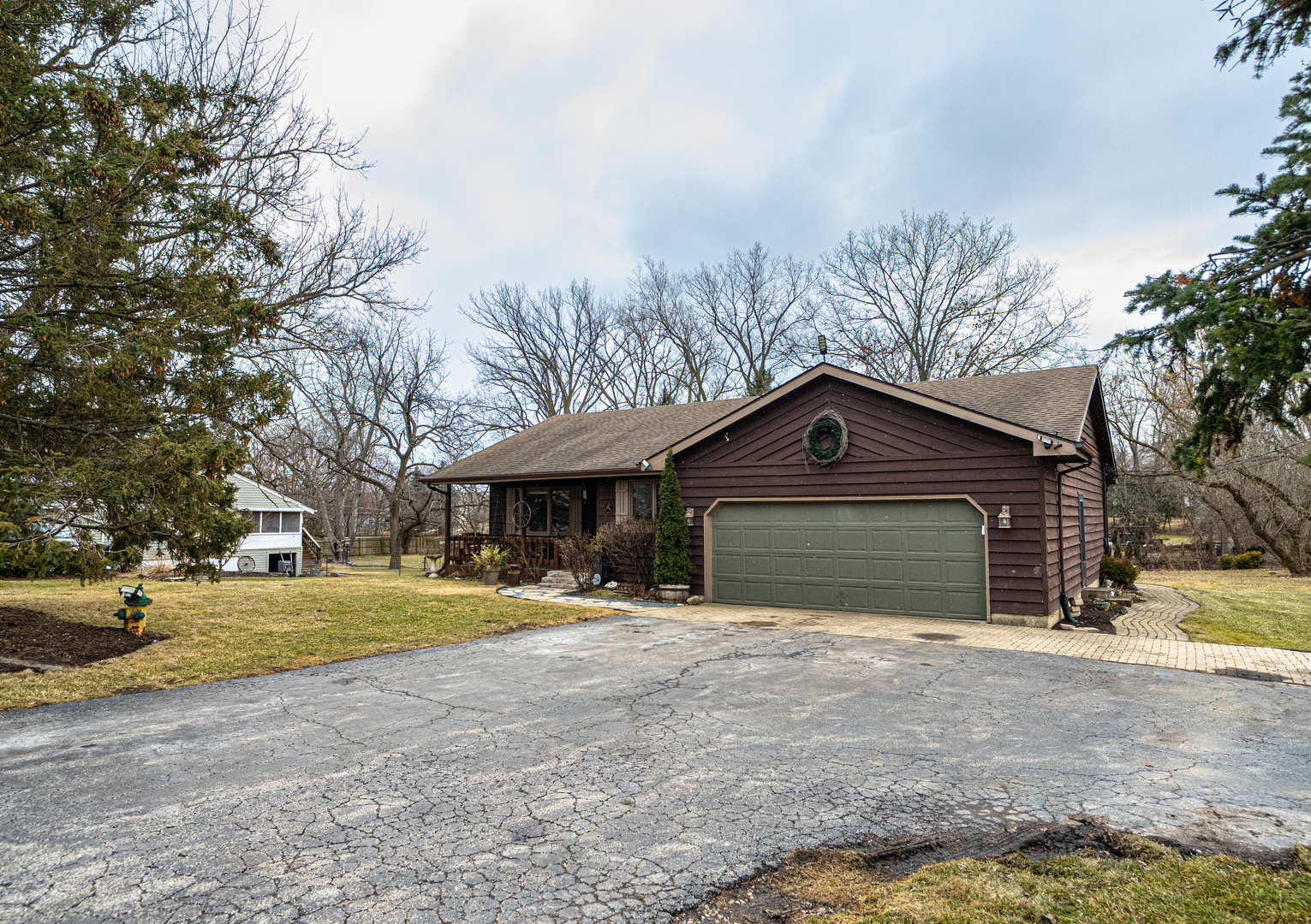 1403 West Beach Road Waukegan, IL 60087 - Photo 6 of 59 a front view of a house with a yard and garage