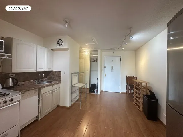 a kitchen with a sink and refrigerator