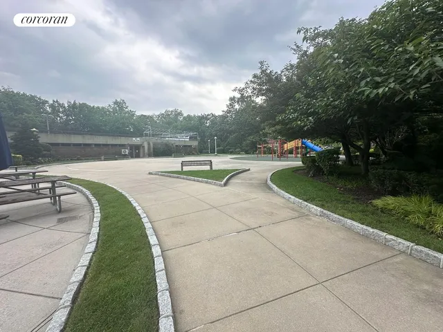 a view of a garden with lawn chairs