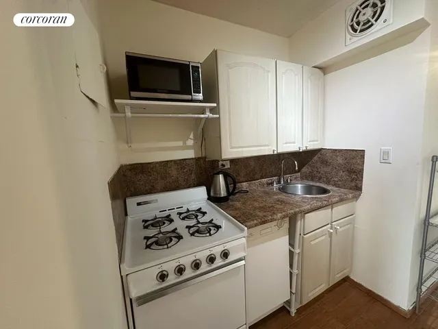 a kitchen with a stove and a microwave