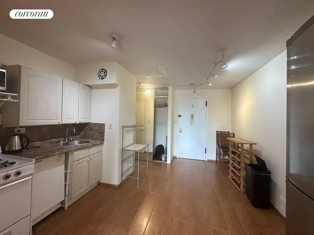 a kitchen with a sink and refrigerator