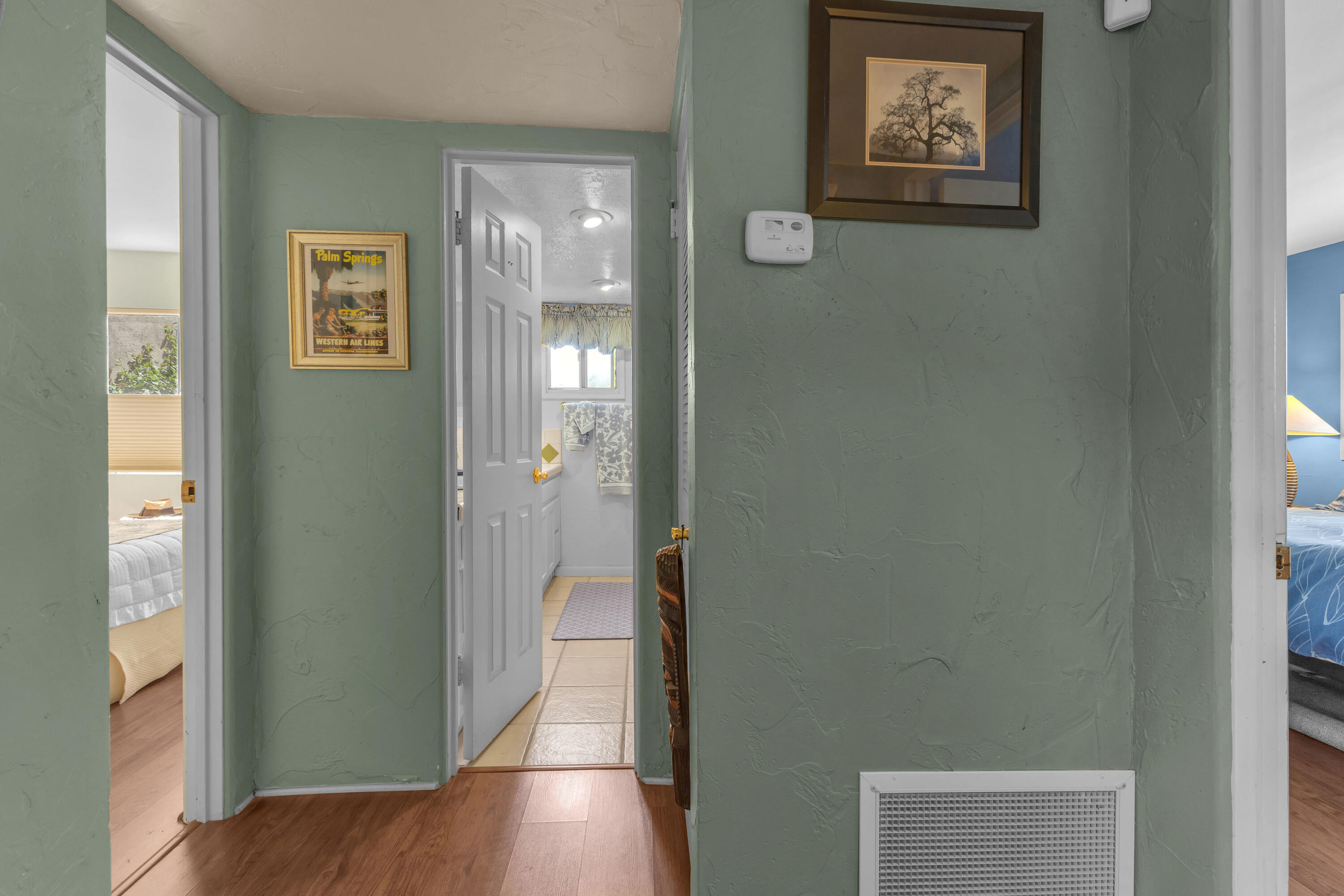 69850 Hwy 111 Rancho Mirage Ca, Unit 14 Rancho Mirage, CA 92270 - Photo 27 of 56 a view of a hallway with paintings on the wall