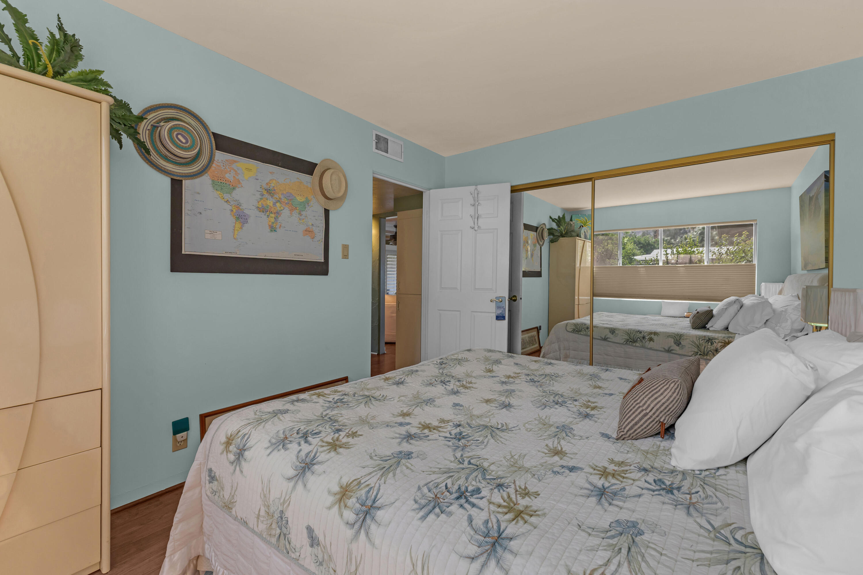 69850 Hwy 111 Rancho Mirage Ca, Unit 14 Rancho Mirage, CA 92270 - Photo 29 of 56 a bedroom with a bed and a large mirror next to a window