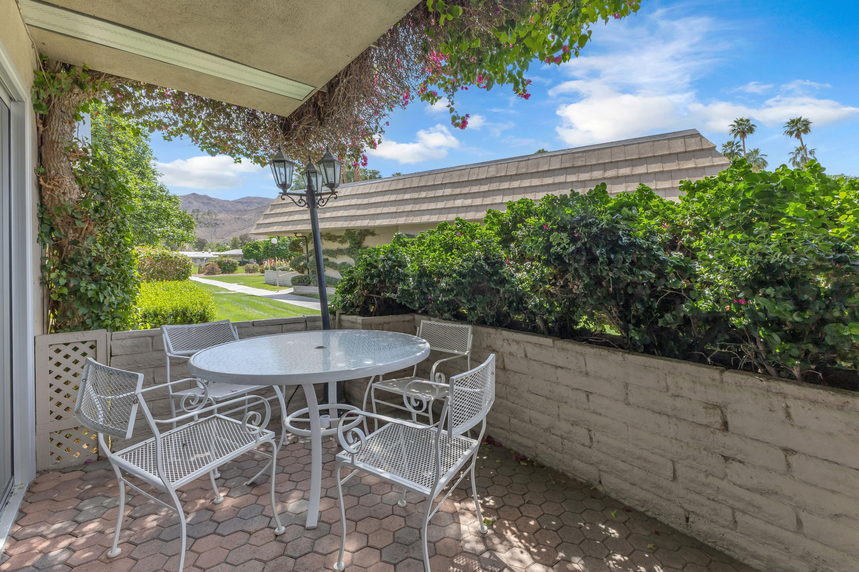 69850 Hwy 111 Rancho Mirage Ca, Unit 14 Rancho Mirage, CA 92270 - Photo 3 of 56 a view of an outdoor dining space with a table and chairs