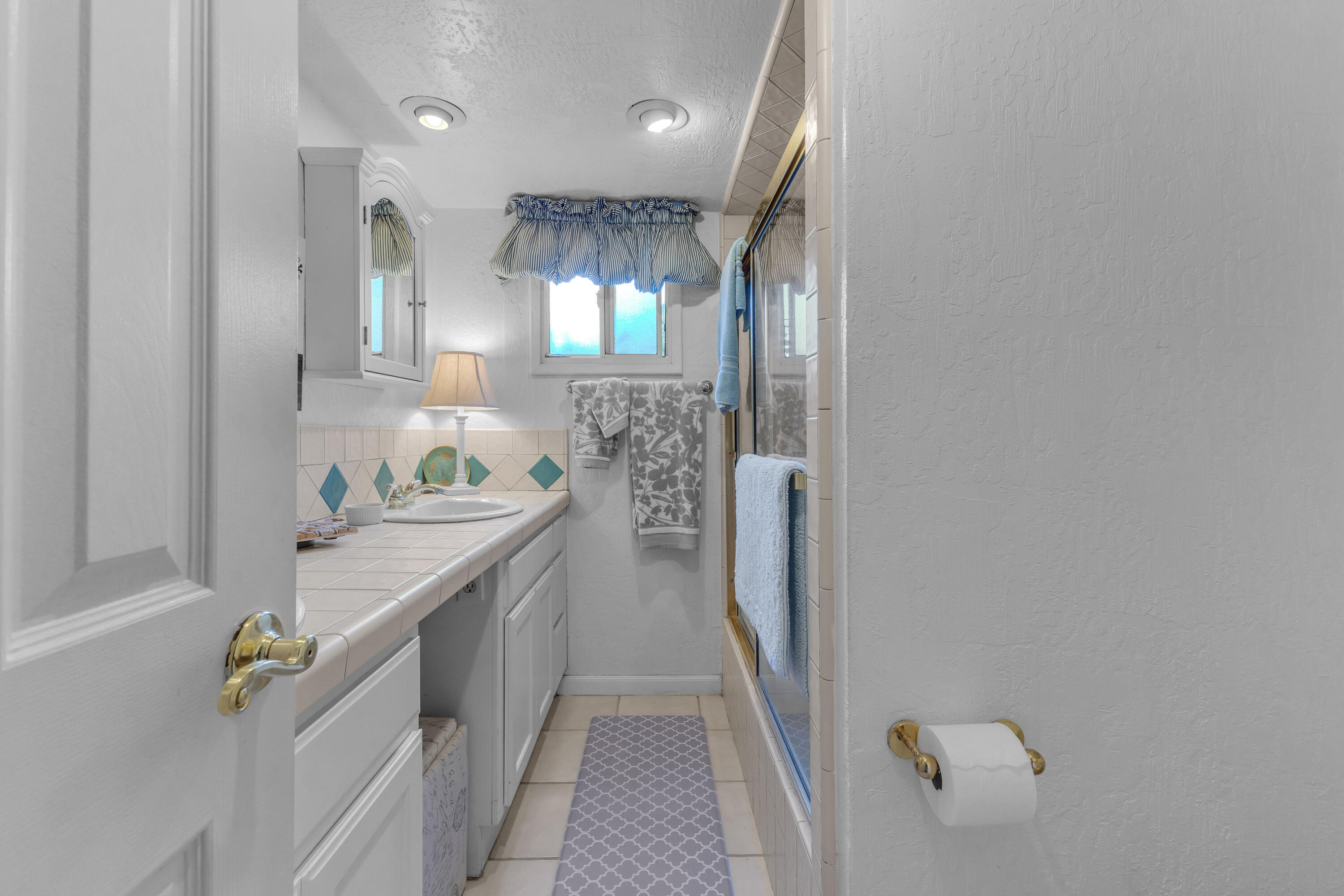 69850 Hwy 111 Rancho Mirage Ca, Unit 14 Rancho Mirage, CA 92270 - Photo 31 of 56 a bathroom with a granite countertop sink a toilet and shower