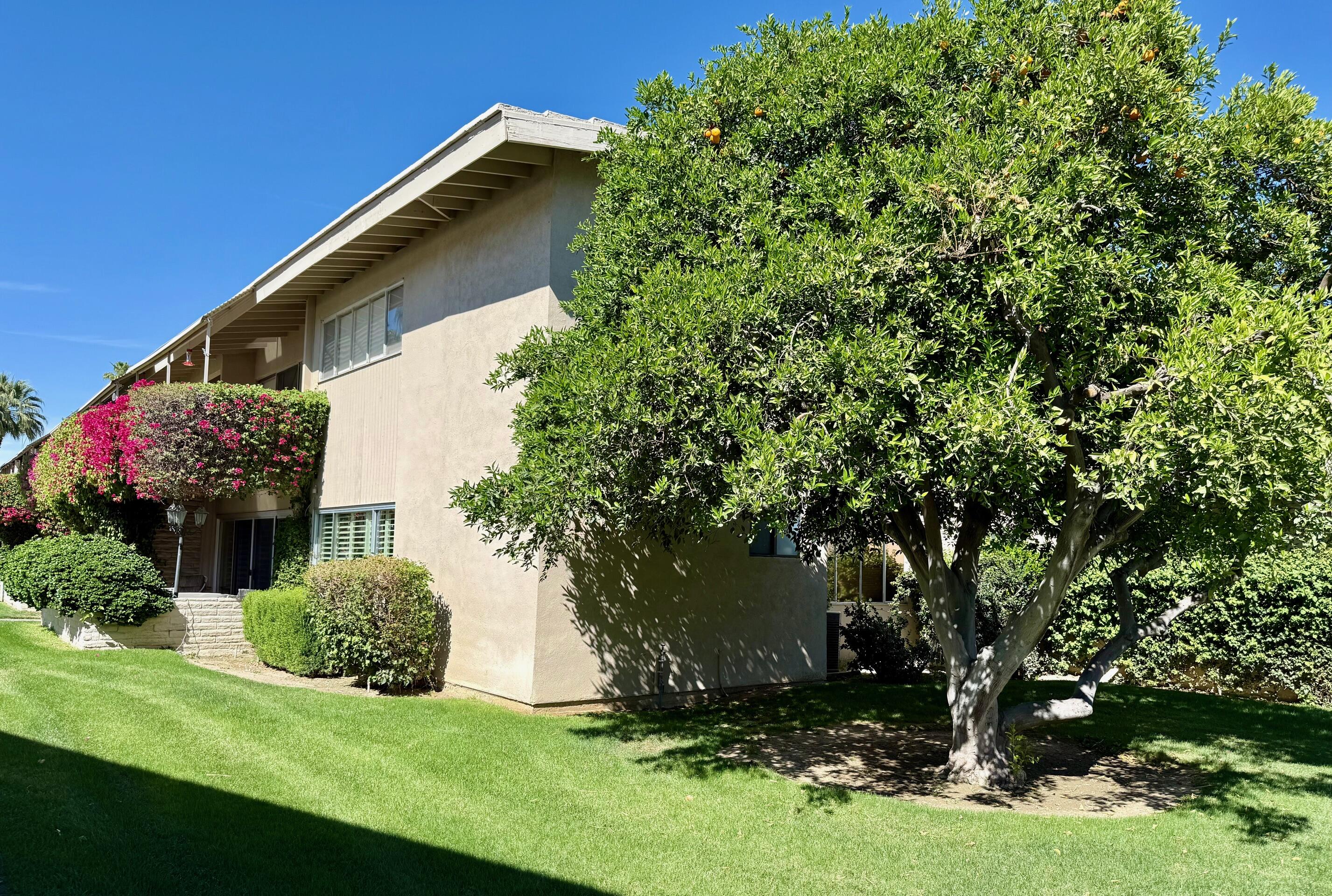 69850 Hwy 111 Rancho Mirage Ca, Unit 14 Rancho Mirage, CA 92270 - Photo 54 of 56 a view of a house with a yard