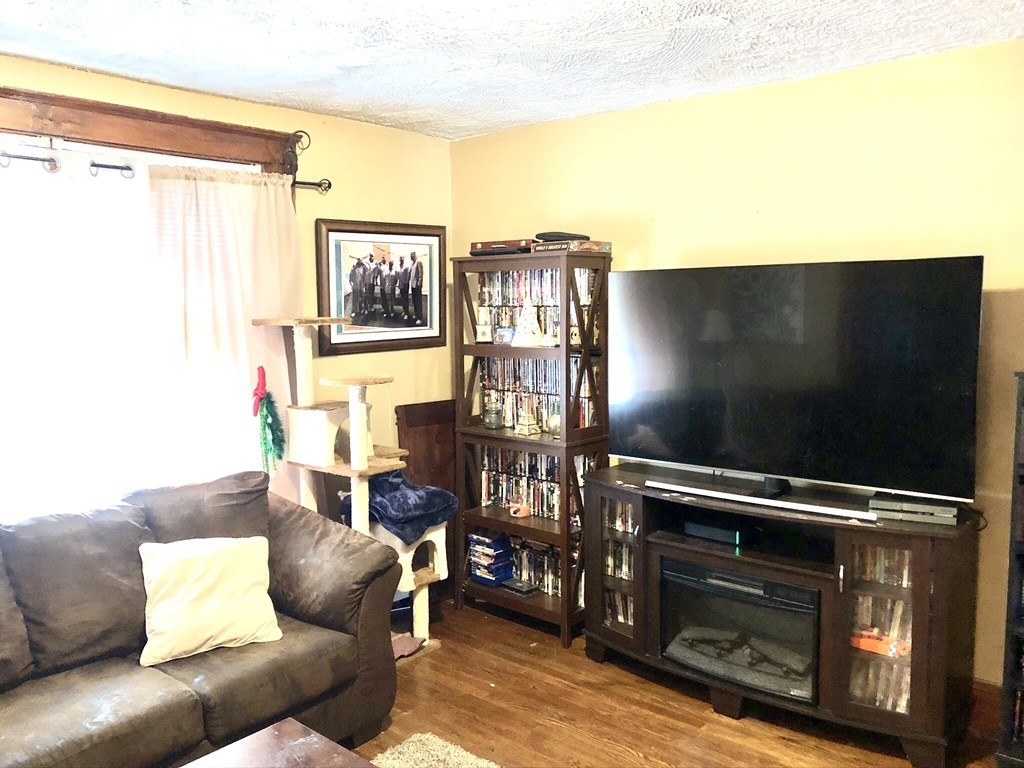 88 Congress Street, Unit 3 Salem, MA 01970 - Photo 9 of 15 a living room with furniture and a fireplace