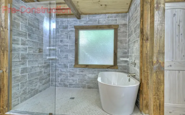 a bathroom with a bathtub and shower