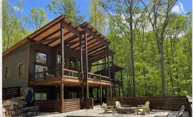 a view of a house with a yard and sitting area