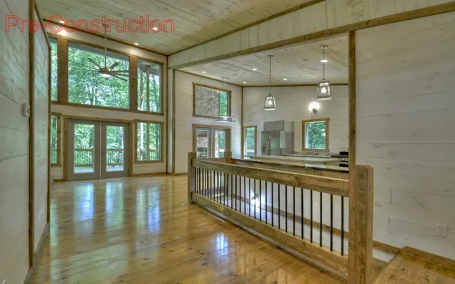 a view of a large room with wooden floor and windows