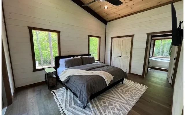 a bedroom with a bed and wooden floor
