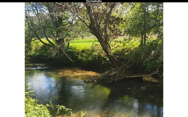 a view of water with a yard
