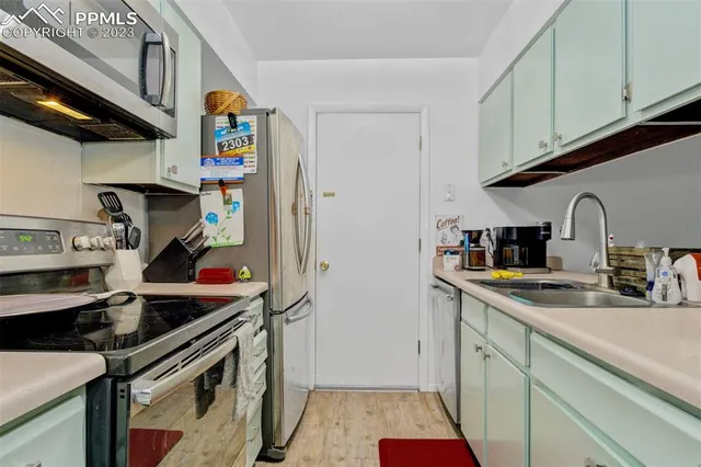 a kitchen with stainless steel appliances granite countertop a sink and cabinets