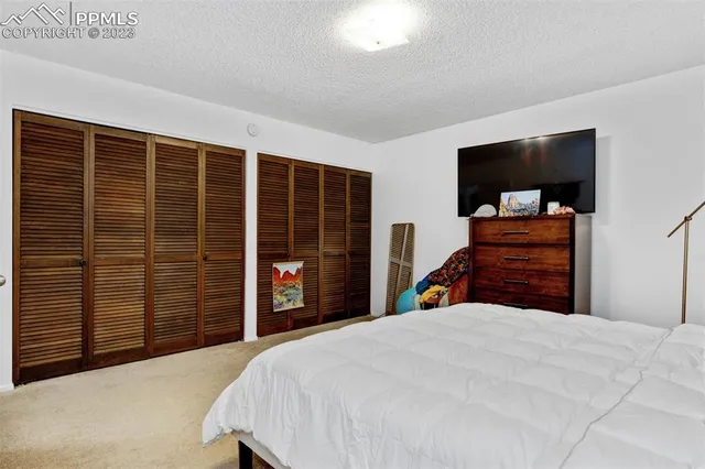 a bedroom with a bed and a television