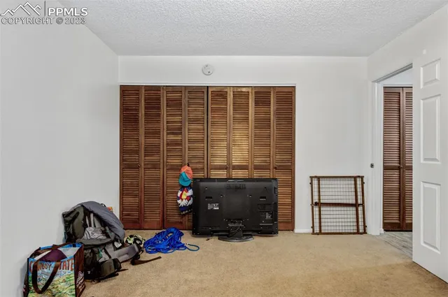 a view of a livingroom with furniture and a window
