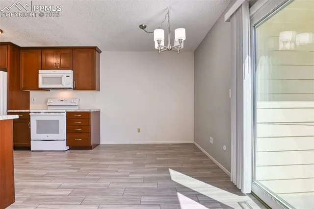 a view of a livingroom with wooden floor and a large window