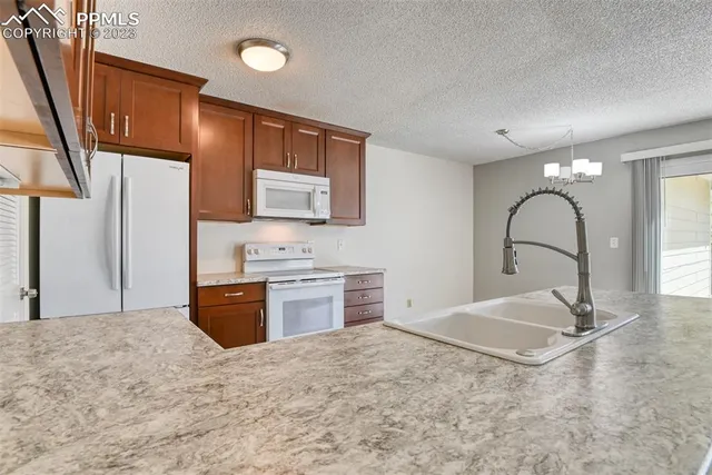 a kitchen with sink and cabinets