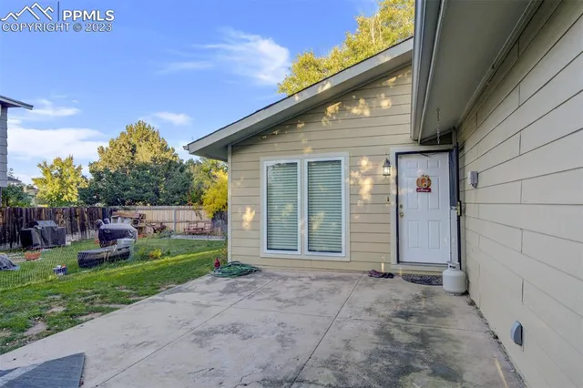 a backyard of a house with plants and outdoor seating