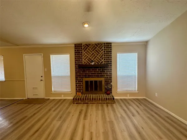 a living room with furniture a fireplace and a table