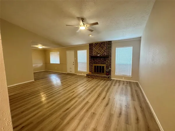 a spacious bedroom with a bed and a cabinets
