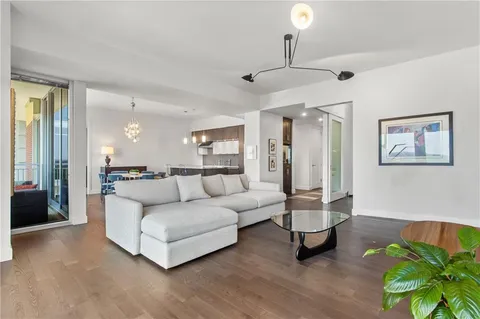 a living room with furniture and a chandelier