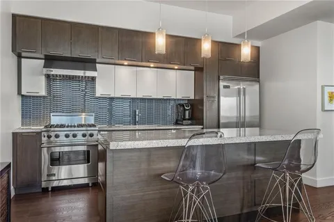 a kitchen with a stove a sink and cabinets