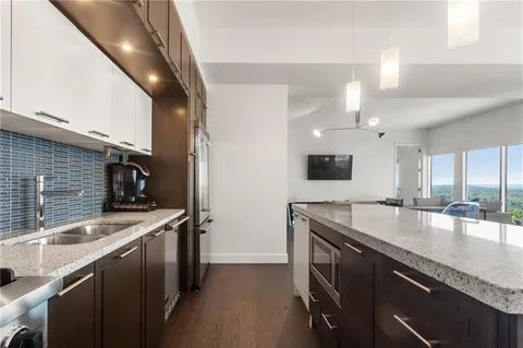 a kitchen with stainless steel appliances granite countertop a sink and a stove