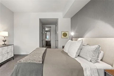 a bedroom with a bed and a lamp