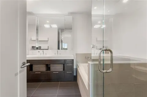 a bathroom with a sink a toilet and mirror