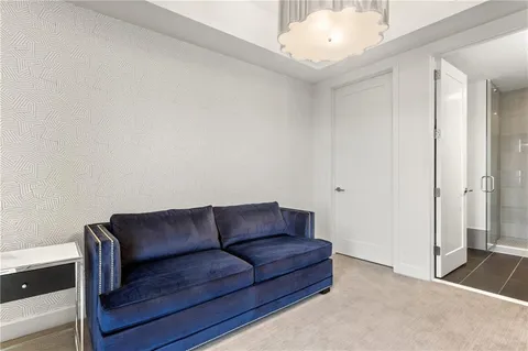 a living room with furniture and a air conditioner vent