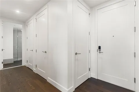 a view of a hallway with wooden floor