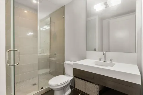 a bathroom with a sink toilet and shower