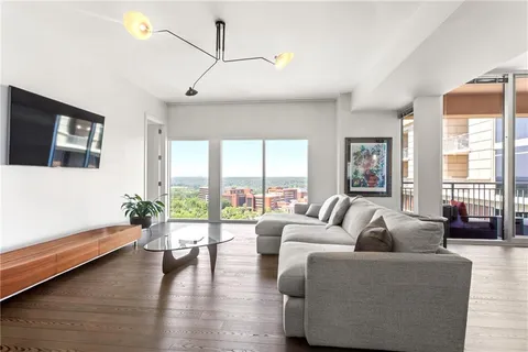 a living room with furniture and large windows