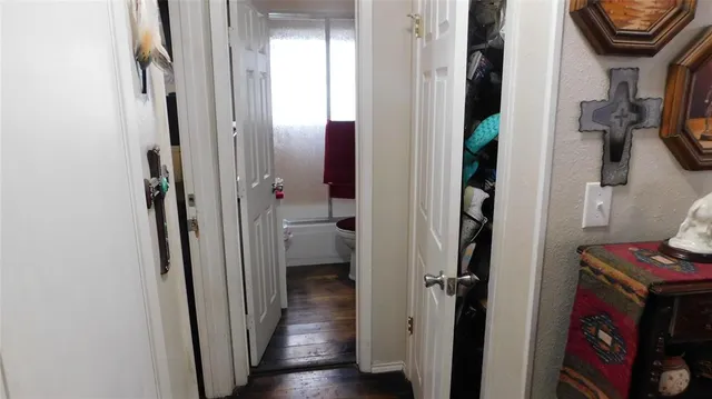 a view of hallway with wooden floor