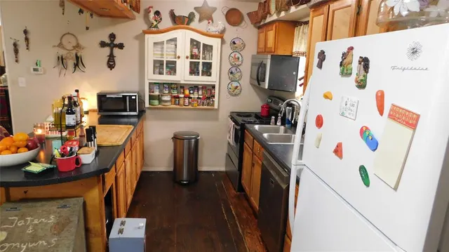 a kitchen with a refrigerator and a stove