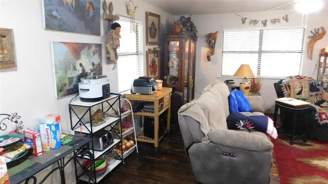 a living room with furniture a fireplace and a chandelier