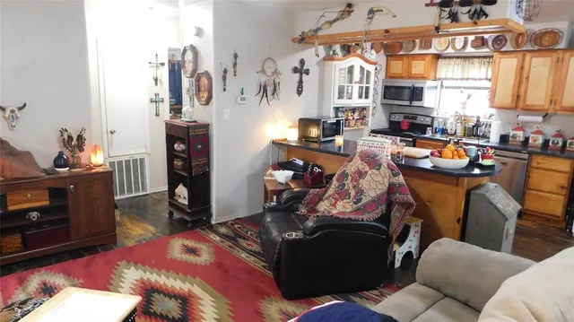 a view of a workspace with furniture and a window