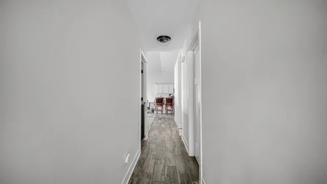 a view of a hallway with wooden floor