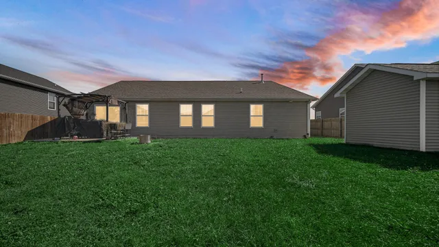 a front view of a house with a yard and outdoor seating