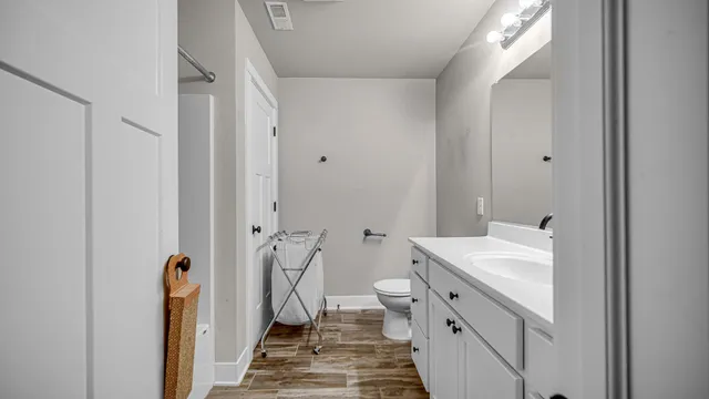 a bathroom with a double vanity sink toilet and shower