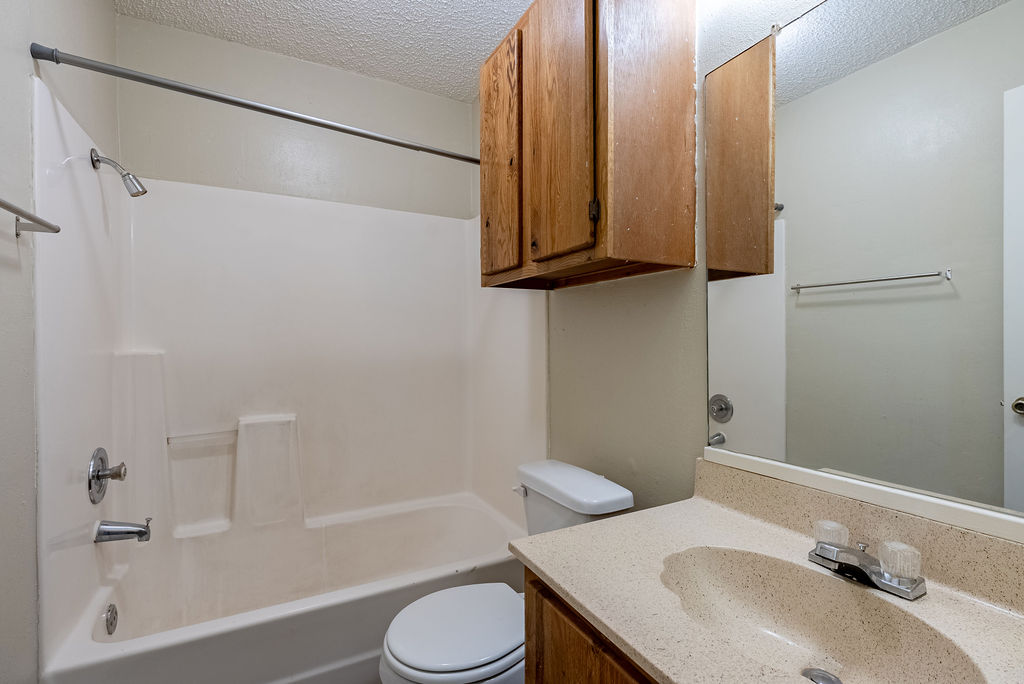 1205 Inland Greens, Unit B Austin, TX 78758 - Photo 11 of 17 a bathroom with a sink toilet and shower