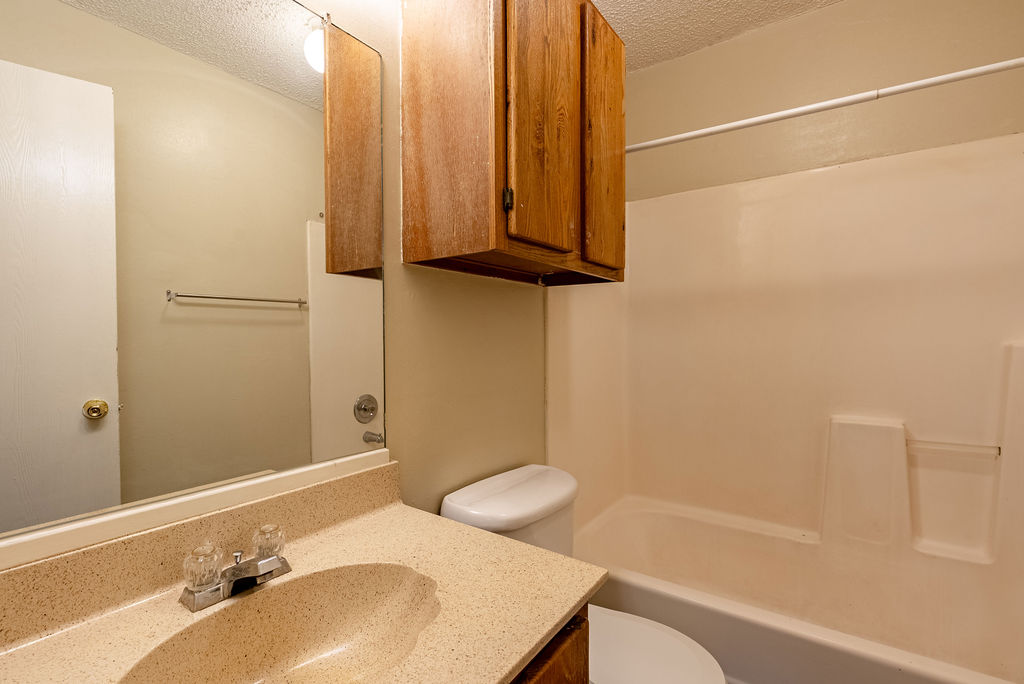 1205 Inland Greens, Unit B Austin, TX 78758 - Photo 14 of 17 a bathroom with a sink and a mirror