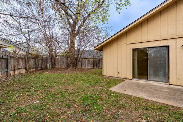 a view of a backyard with large trees