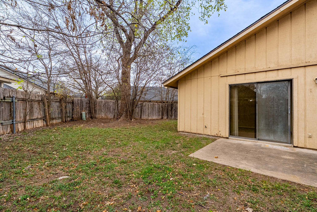 1205 Inland Greens, Unit B Austin, TX 78758 - Photo 16 of 17 a view of a backyard with large trees