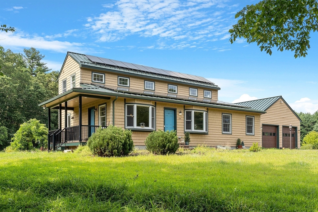 a front view of house with yard and green space