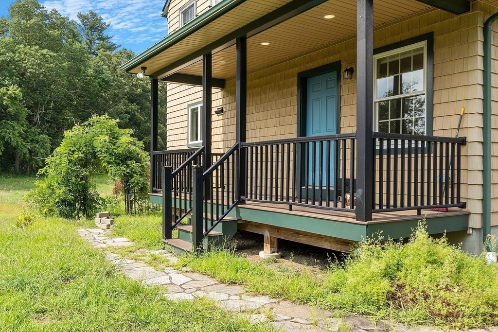 295 Pond Street Dunstable, MA 01827 - Photo 12 of 14 a front view of a house with a yard table and chairs