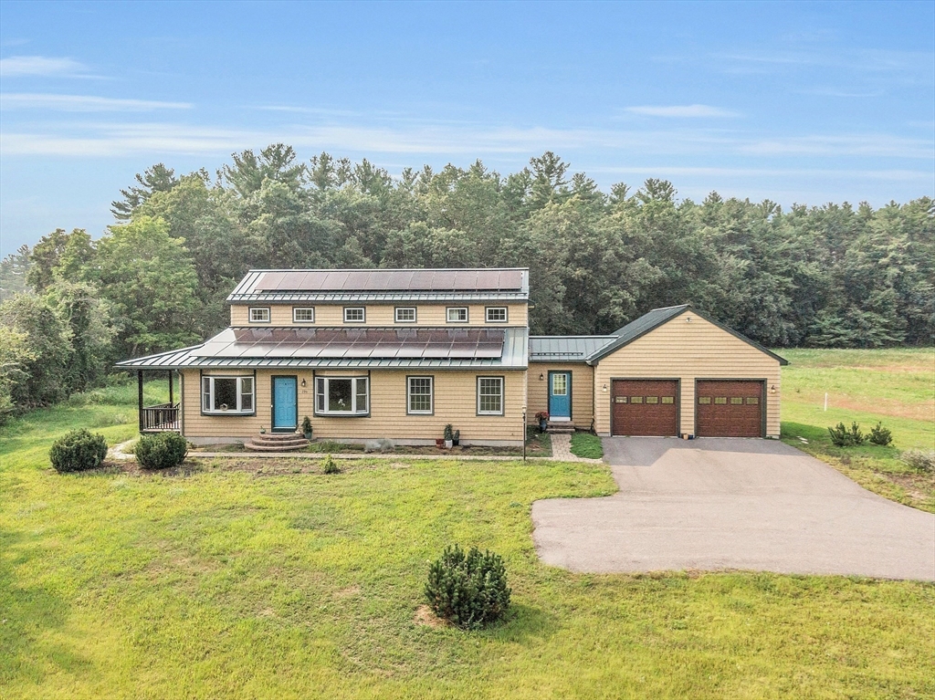 295 Pond Street Dunstable, MA 01827 - Photo 4 of 14 a front view of a house with a yard