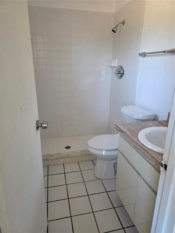 9000 Griggs Road, Unit G Englewood, FL 34224 - Photo 11 of 24 a bathroom with a toilet a sink and a shower