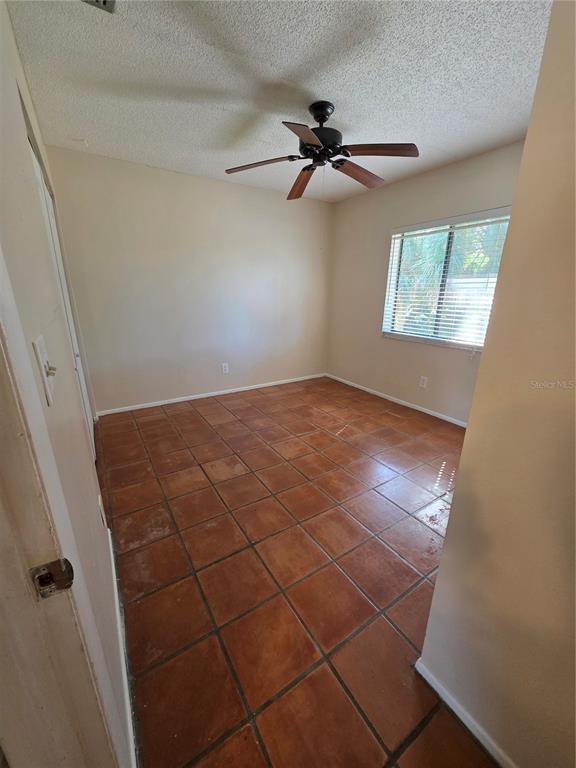 9000 Griggs Road, Unit G Englewood, FL 34224 - Photo 13 of 24 a view of a room with a ceiling fan and window